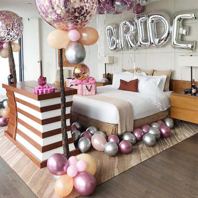 Elegant bridal suite decorated with balloons and a "GIRL" banner.