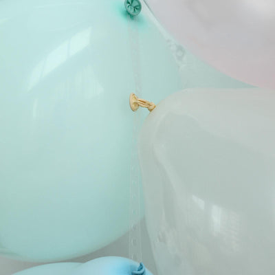 Colorful balloons in various shades of blue and white, tied together.