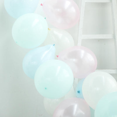 Pastel balloons in shades of blue and pink, floating against a white backdrop.