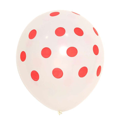 White balloon with red polka dots, studio shot.