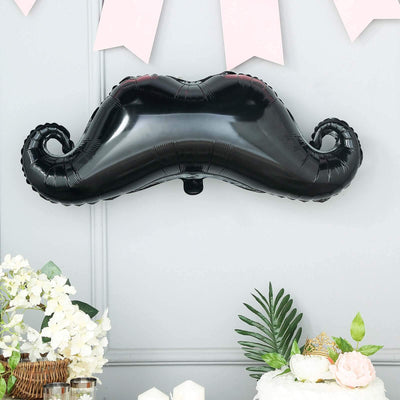 Black mustache-shaped balloon decoration for parties and events.