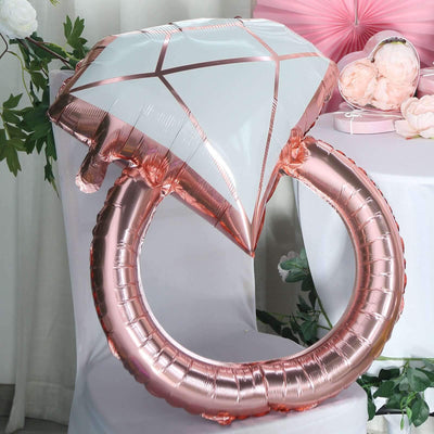 Rose gold diamond ring balloon on a chair.