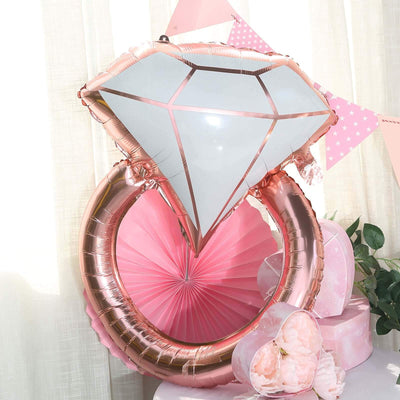 Rose gold diamond ring balloon decoration for parties and celebrations.