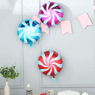 Colorful swirl balloons in blue, pink, and red for festive decorations.