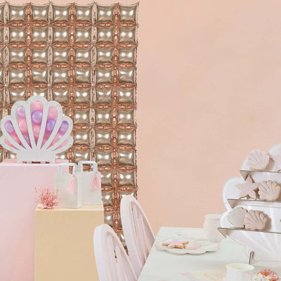 Decorative shell centerpiece in a pastel-themed party setting.