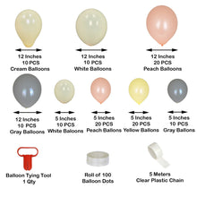A bunch of latex balloons in peach, gray, cream, white, and yellow colors with a balloon tying tool