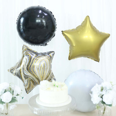 Balloon decorations in black, gold, and star shapes above a white cake.