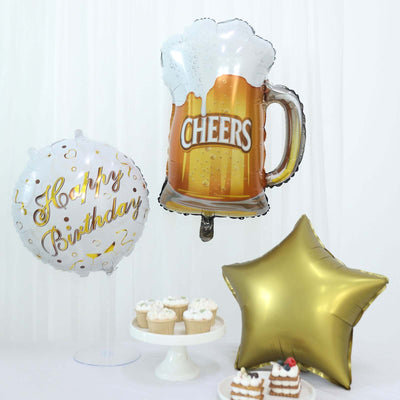 Beer mug and star-shaped balloons with "Happy Birthday" text, festive celebration decor.