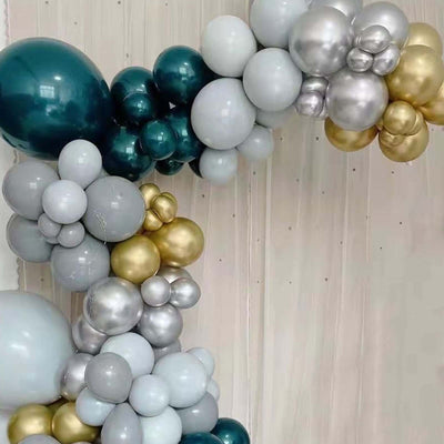 Colorful balloon arch in teal, silver, and gold shades.