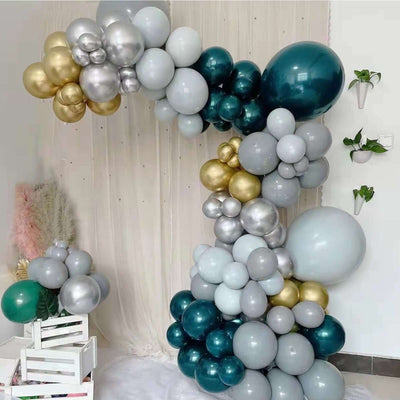 Colorful balloon arch decoration in teal, silver, gold, and gray.