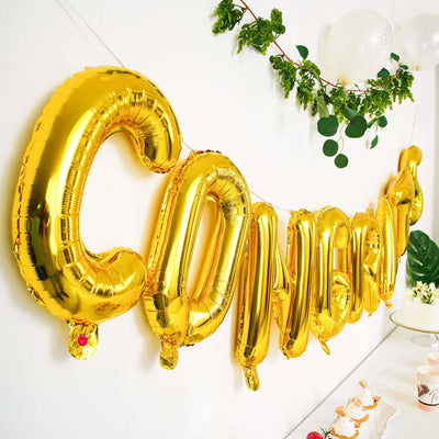 Gold "CONGRATS" balloons for celebration decor.