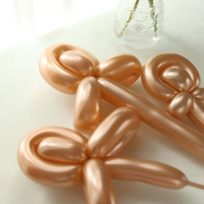 Peach-colored balloon decorations arranged on a table.