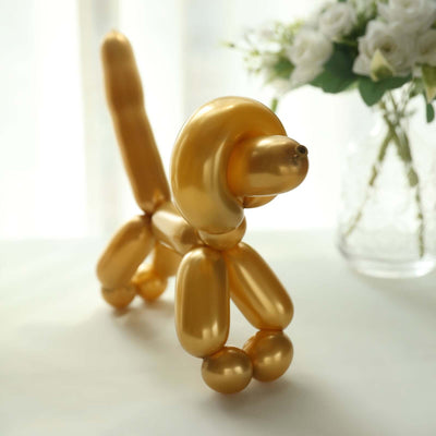 Gold balloon animal dog sculpture with a floral backdrop.