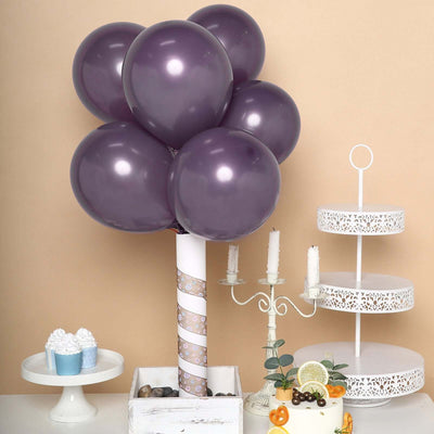 Purple balloon bouquet centerpiece with cake stand and dessert display.