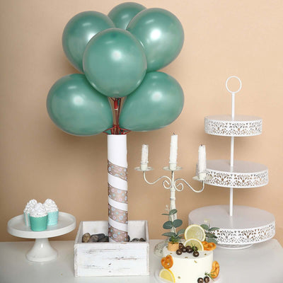 Decorative teal balloon centerpiece with cake and dessert display.