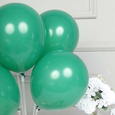 Green glossy balloons against a neutral background.