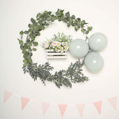 Decorative wall arrangement with flowers, greenery, and light blue balloons.