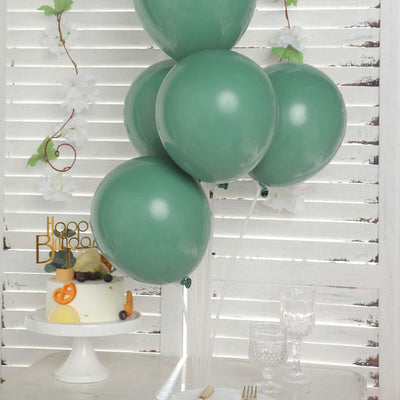 Green balloons with a birthday cake and decorative elements in a festive setting.