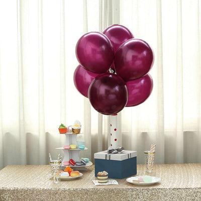 Purple balloons and a gift box centerpiece at a festive table setting.