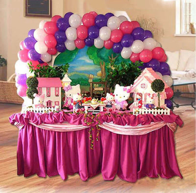 Colorful Hello Kitty-themed party decoration with balloons and table setup.