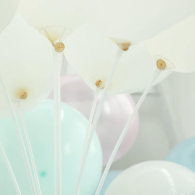 White and pastel balloons with clear strings in a festive arrangement.