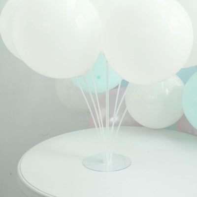 White balloons arranged on a clear stand against a plain background
