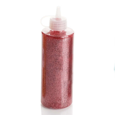 Red glitter glue bottle with a nozzle cap on a white background