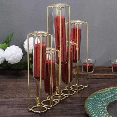 Gold metal vase holder with red glitter tubes, stylish decor for home or events.