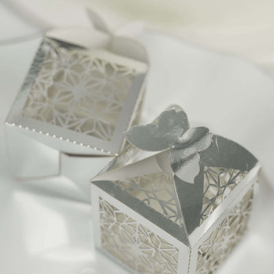 Silver decorative gift boxes with intricate designs and butterfly tops.