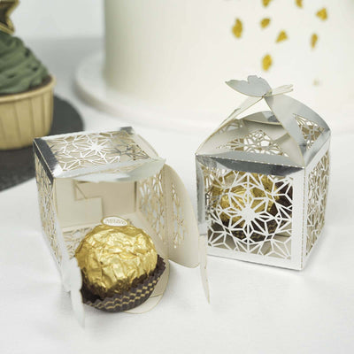 Elegant silver gift box with a chocolate truffle inside.
