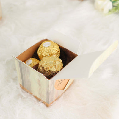 Box of chocolate truffles with gold foil, open on a soft, textured background.