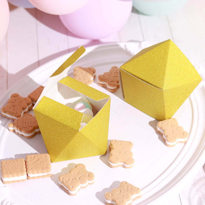 Yellow glitter gift boxes with cookies on a white platter.