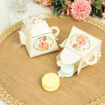 Decorative tea party favor boxes with macarons on a rustic platter.