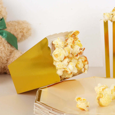 Golden popcorn box with fluffy popcorn spilling out, set against a plain backdrop.