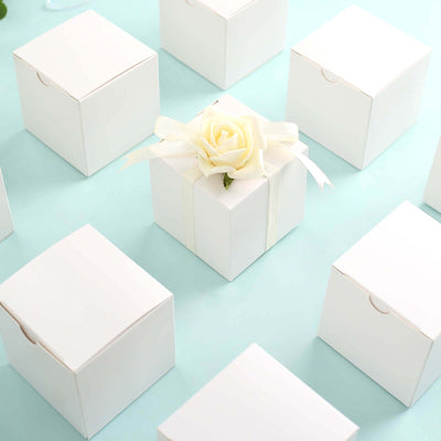 White gift box with a rose decoration among other plain boxes