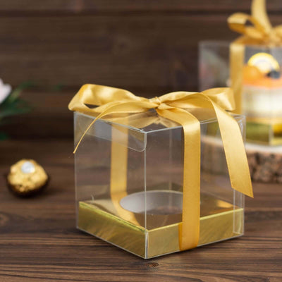 Clear gift box with gold ribbon, perfect for special occasions.