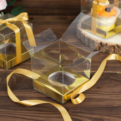 Clear gift box with a golden base and yellow ribbon, perfect for treats.