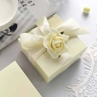 Elegant gift box with a cream ribbon and rose decoration.