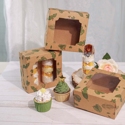 Assorted dessert packaging boxes with transparent windows and decorative designs.