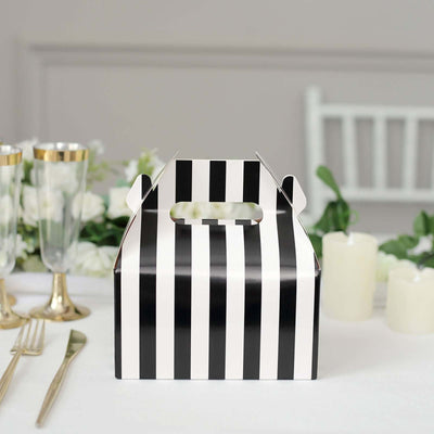 Black and white striped gift box on a dining table with decor.