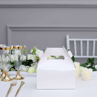 White gift box on a festive table with flowers and elegant decor.