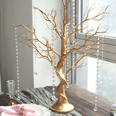 Gold decorative tree with hanging crystals, perfect for elegant table settings.