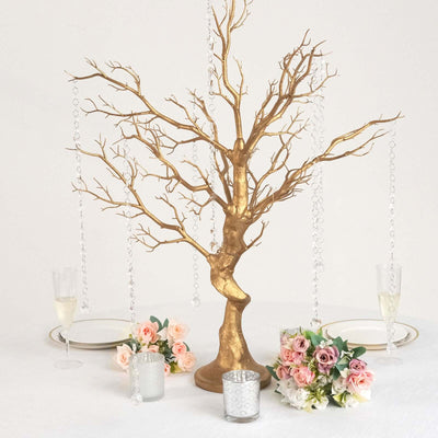 Gold decorative tree centerpiece with hanging crystals and floral arrangements.