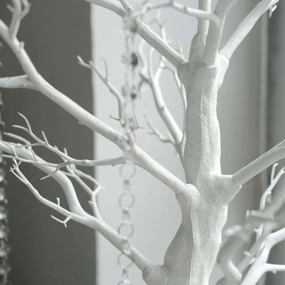 White decorative tree with branches and hanging crystals.