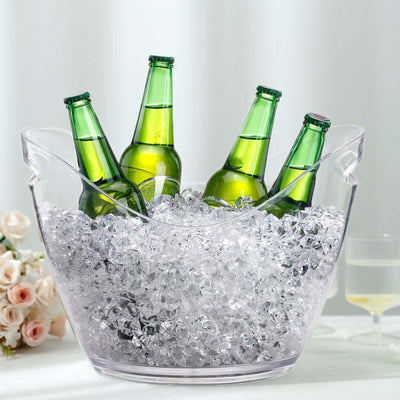 Clear ice bucket with four green bottles and ice, perfect for parties.