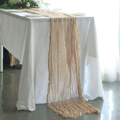 Elegant beige table runner draped over a white table in a bright setting.