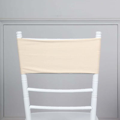 Beige chair cover on a white chiavari chair against a plain background.