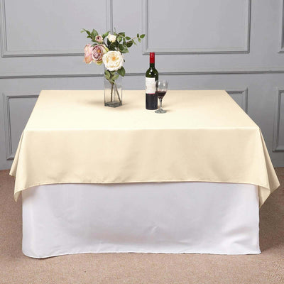 Elegant beige tablecloth draped over a table with flowers and wine.