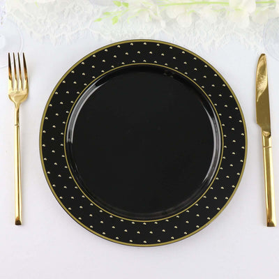 Elegant black plate with gold accents, styled with gold cutlery.
