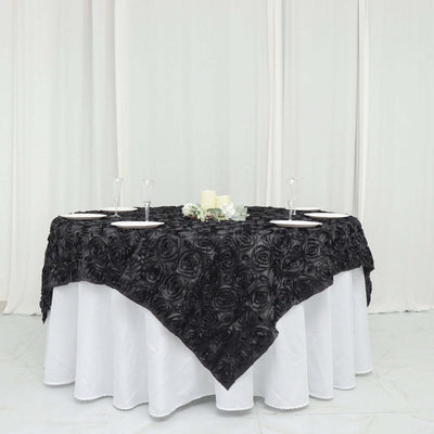 Black rose tablecloth draped over a white table set for dining.